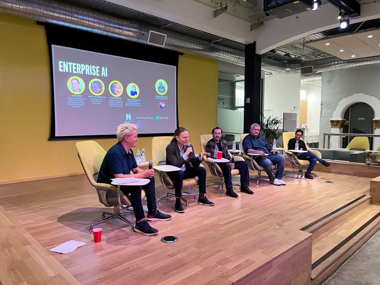 Panelists discussing enterprise AI on stage at an Open Future Forum event