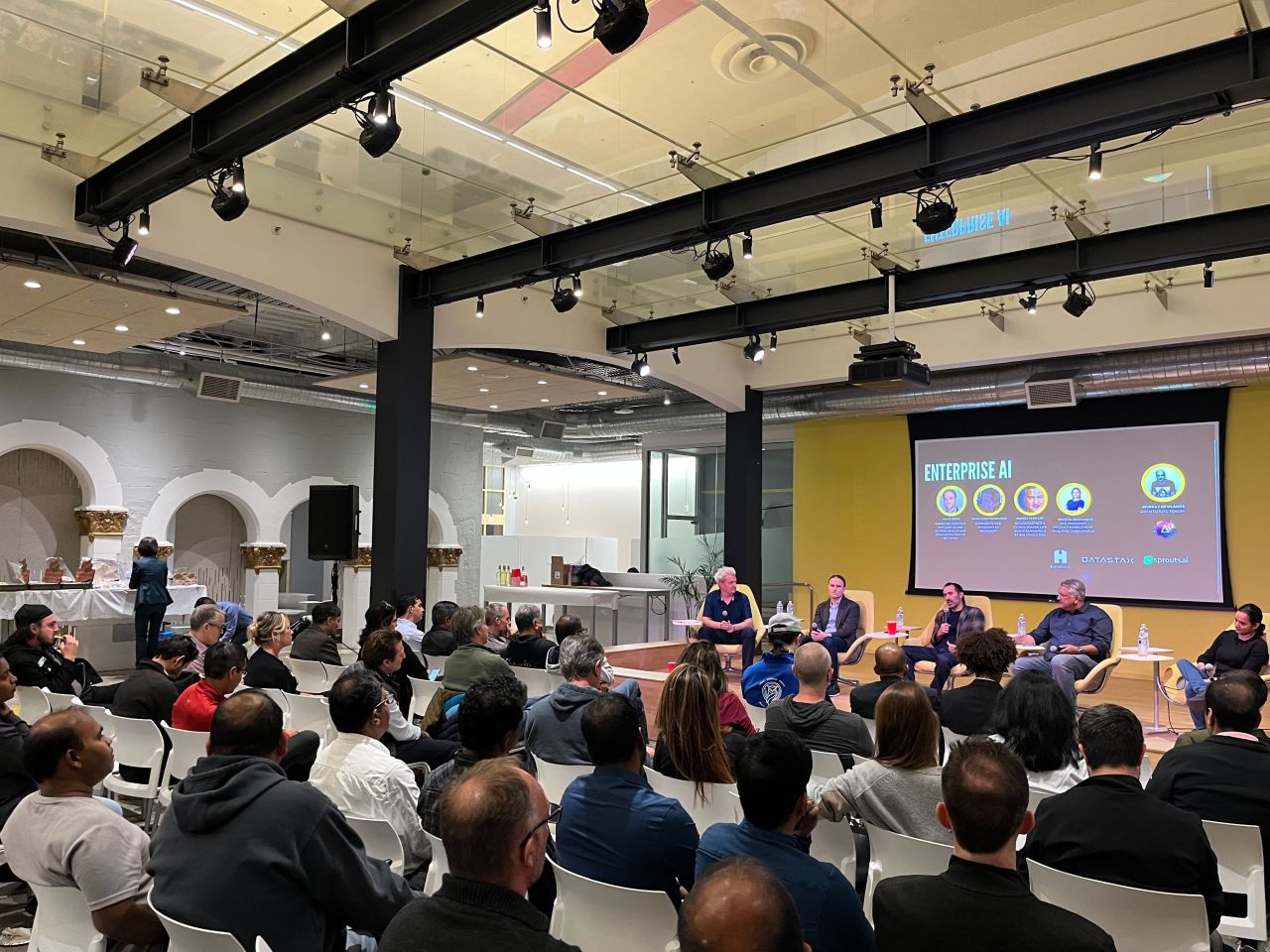 Attendees listening to an enterprise AI panel at an Open Future Forum event