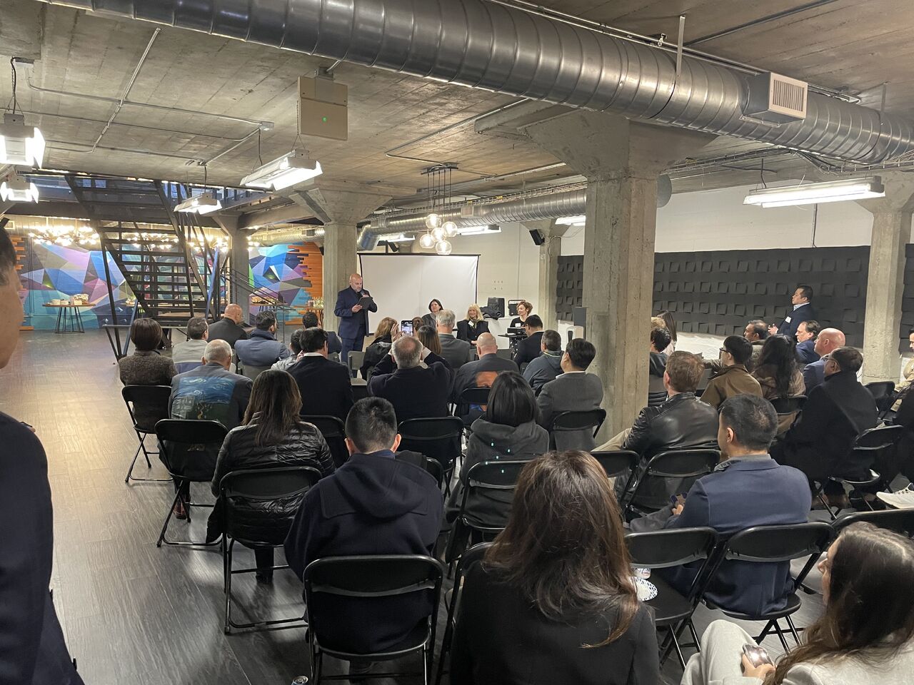 Attendees seated at an Open Future Forum panel event