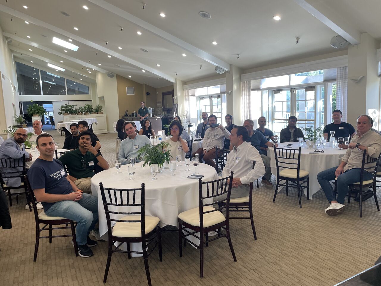 Open Future Forum members seated for a round table dinner
