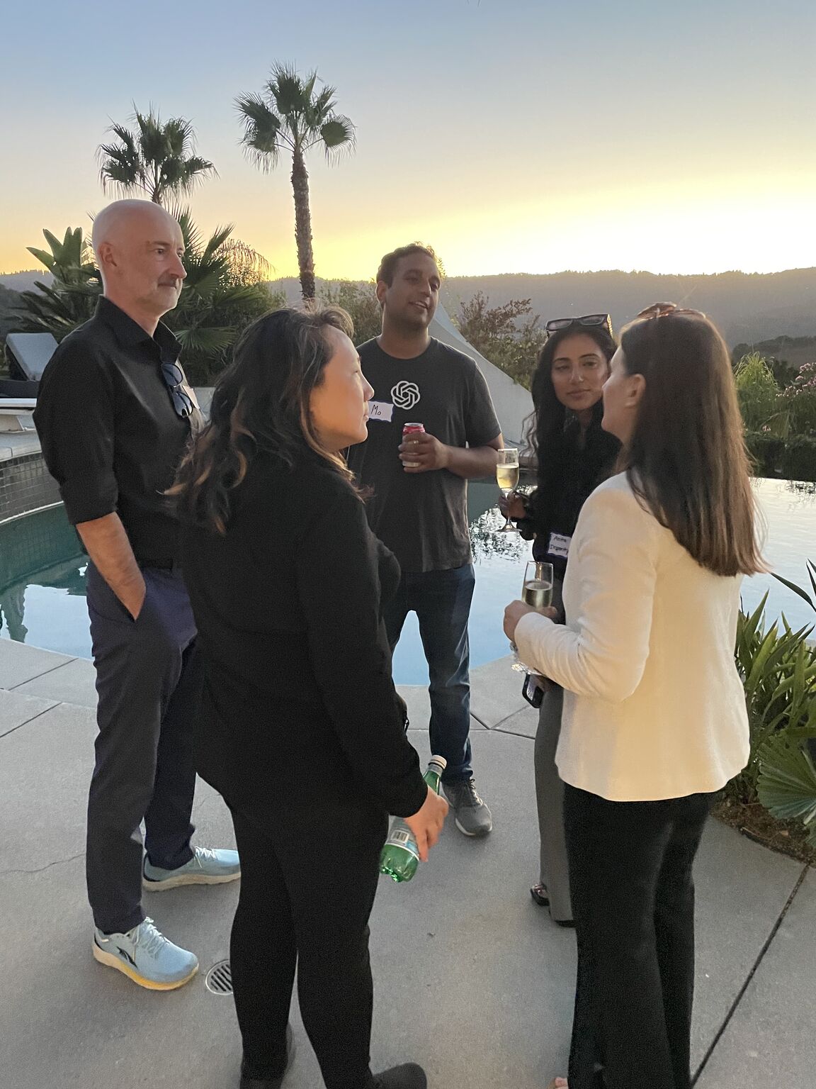 Open Future Forum members together on a patio at sunset